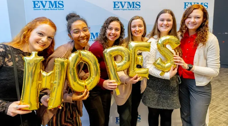 group of student holding balloons that spell HOPES.