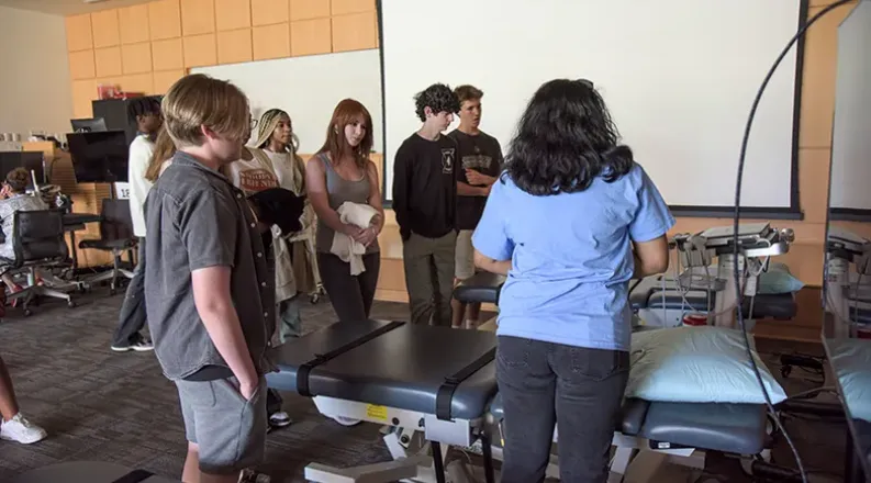 students gathered around ultrasound machine.