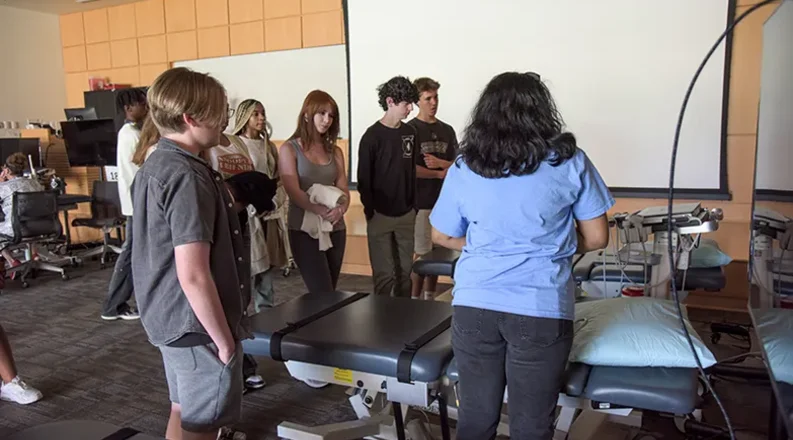 students gathered around ultrasound machine.