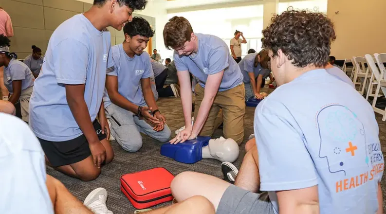 students learning CPR in a classroom.