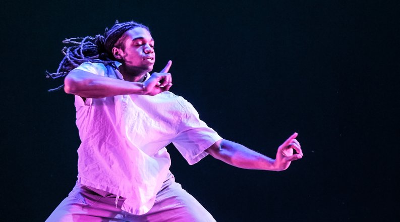 Kameron Clark gestures with his hands in a moment from a previous performance