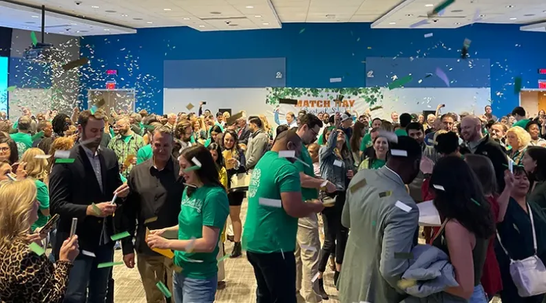 students throwing confetti in the air