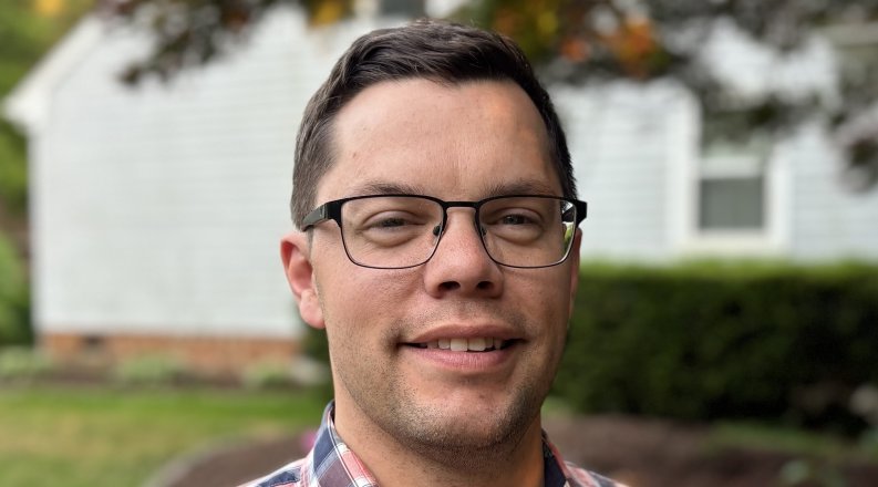 Headshot of man in plaid shirt