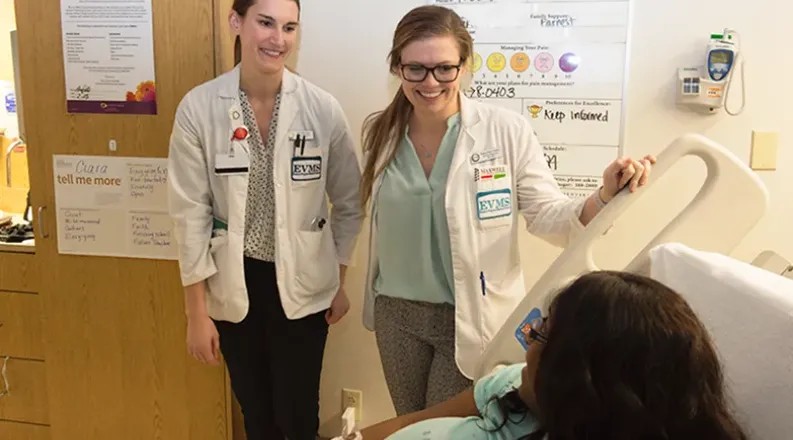 Two students visit a patient in the hospital