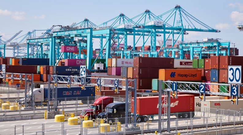 cranes and trucks at port 