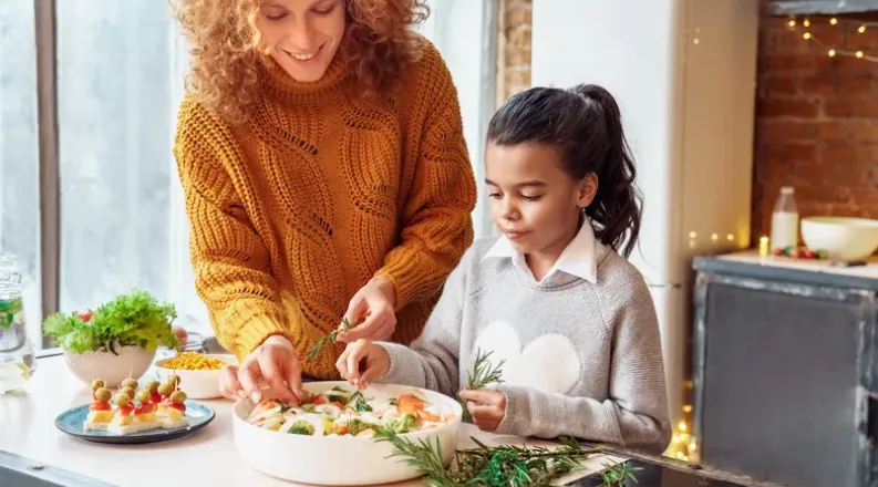 Woman and child making a salad