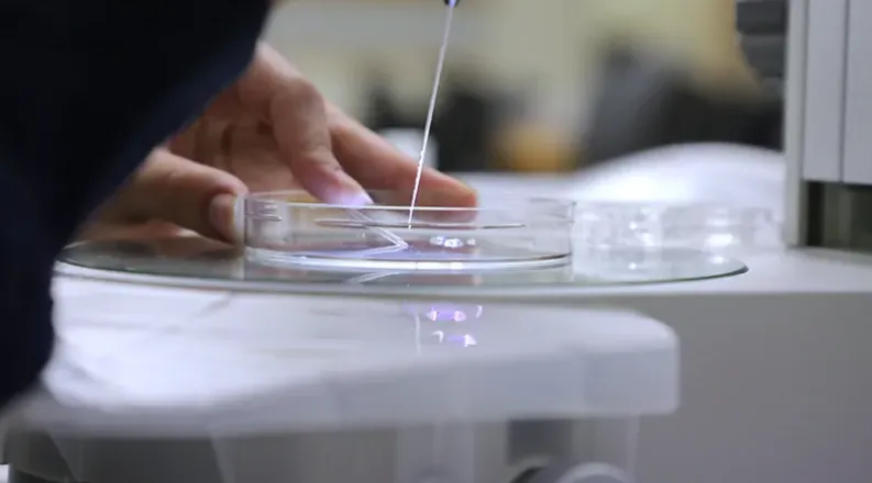 RCS student holds a pipette, close up