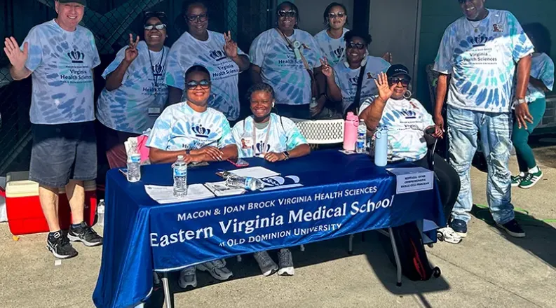 people standing behind a table