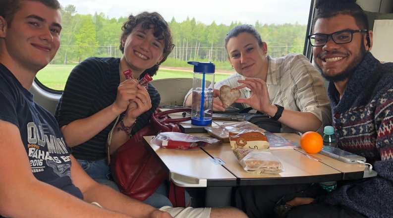 Group of four ODU students on sitting on train.