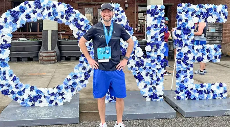 Adam Henry stands with race metal