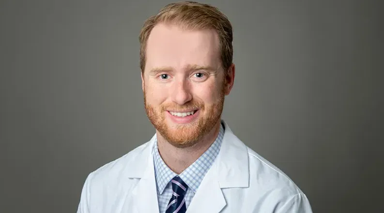 Dr. Whitlock has short strawberry blond hair, beard and must