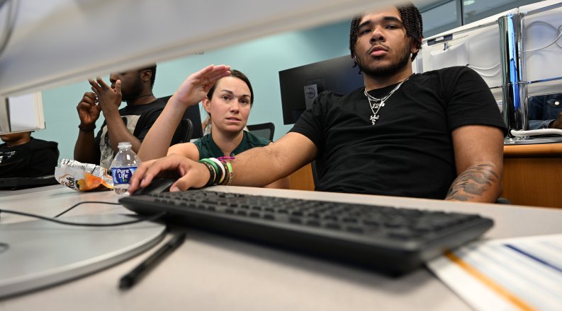 Woman helps a student