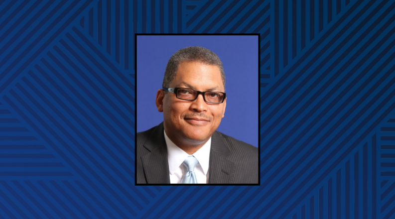 Headshot of a man on a blue, striped background.