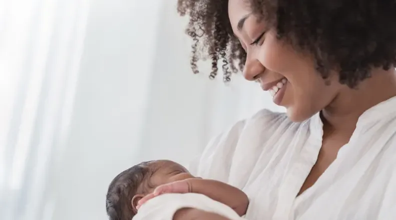 African American woman holding infant