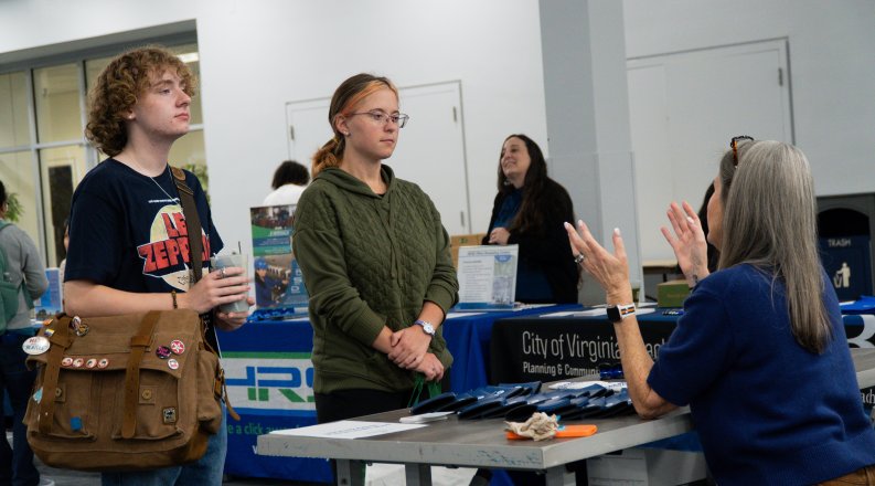 Students talking with a booth rep at the Environmental Career Fair