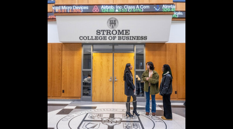 Business students stand in the atrium of Constant Hall.
