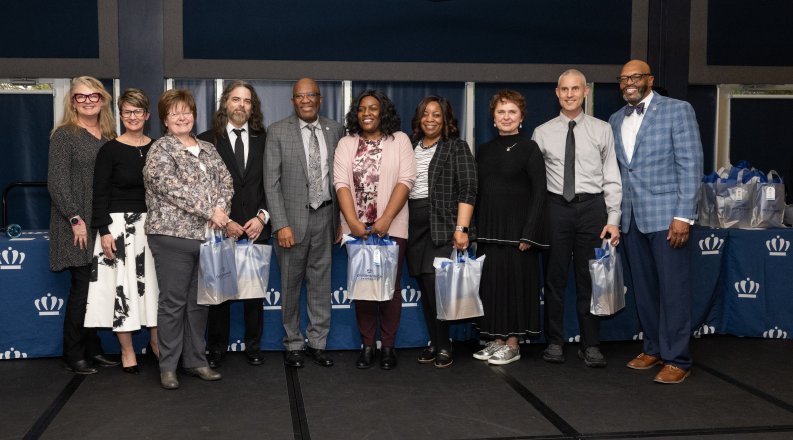 A group of people pose for a photo in one of ODU's conference rooms.