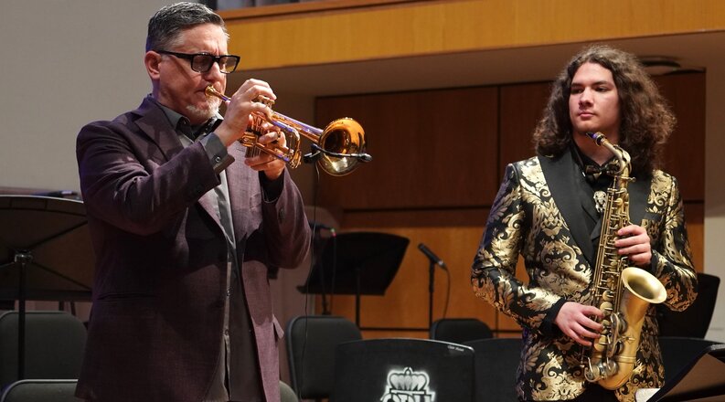 Jazz studies major and saxophone player Jayce Whiddon, right, looks on as visiting artist Rex Richardson plays trumpet solo during his 2026 residency at Old Dominion University. 