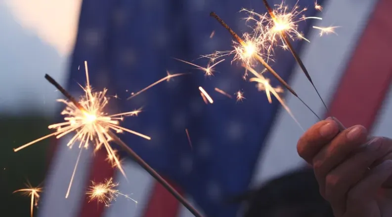 Sparklers in front of an American flag