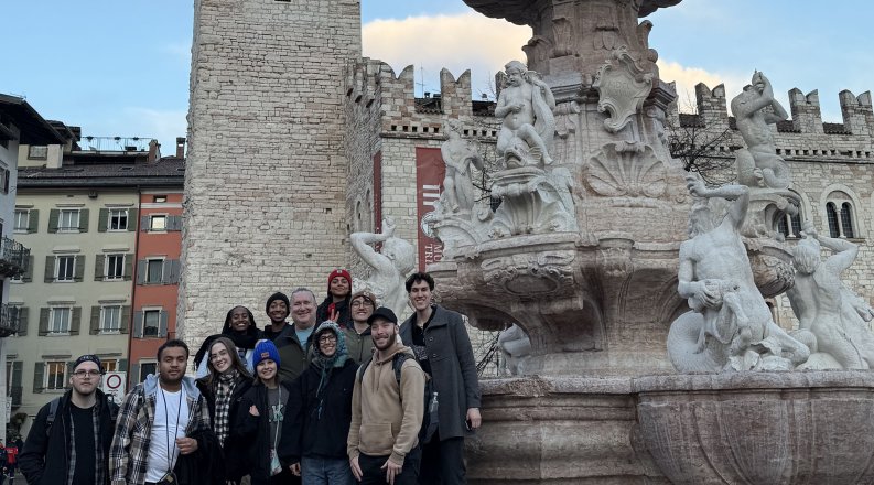 Group of students in front of Fountain of Neptune in Trento.