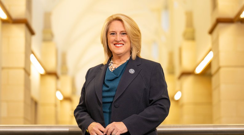 ODU alumna Janet Carter inside a bright hallway.