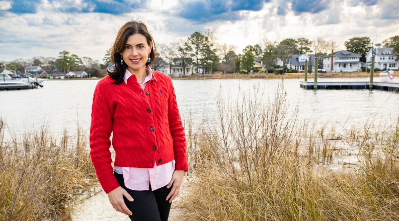 Laura Costadone in front of marshy area with house in background