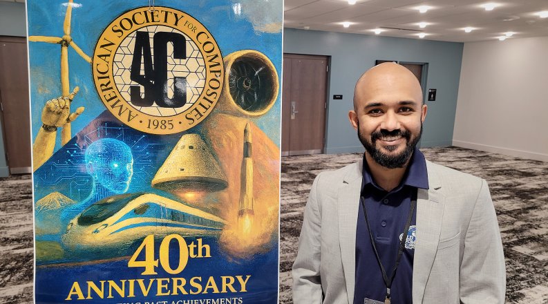 Mohammad Nazmus Saquib smiles for photo beside an American Society for Composites banner.