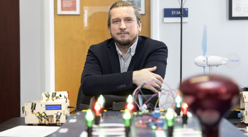 Dr. Mutat Kuzlu sitting at table
