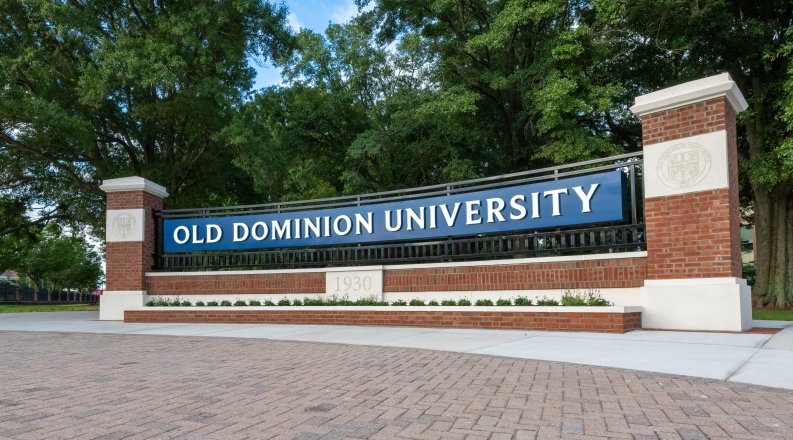 Brick pillars frame a blue and white sign welcoming visitors to Old Dominion University.