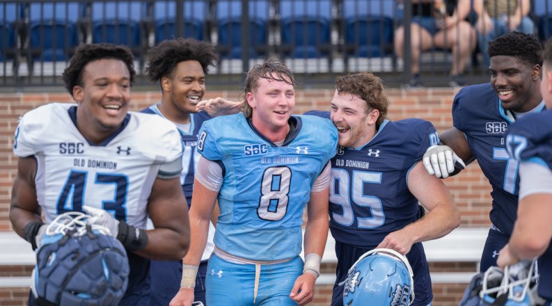 Football players celebrate after scrimmage