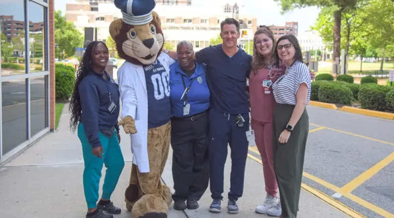 Big Blue mascot with faculty and staff