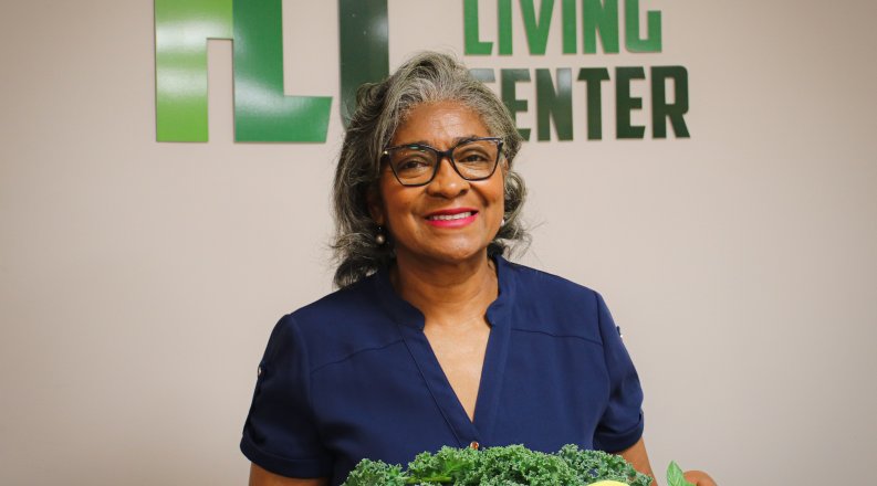 Olivia Newby in front of healthy living center sign