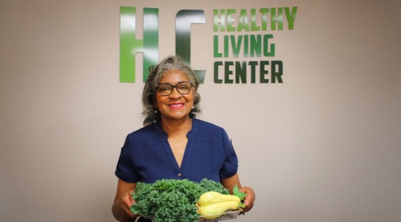 Olivia Newby in front of healthy living center sign