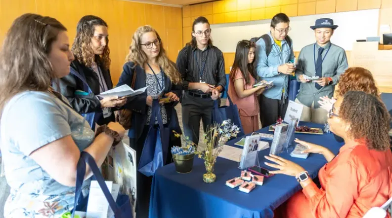 New health professions students visit an information table d