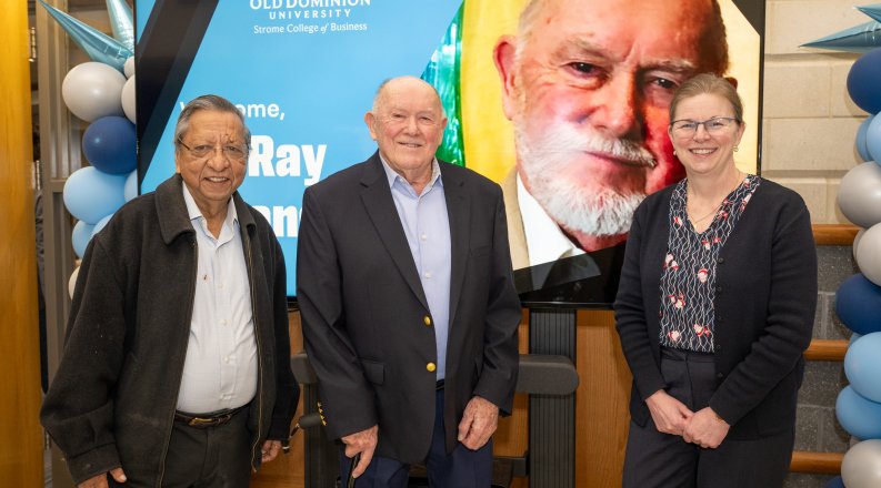 Vinod Argarwal, Ray Strangways and Erika Marsillac stand in front to a post of Ray.
