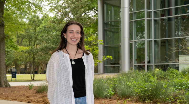 Photo of a female student standing on ODU’s campus. 