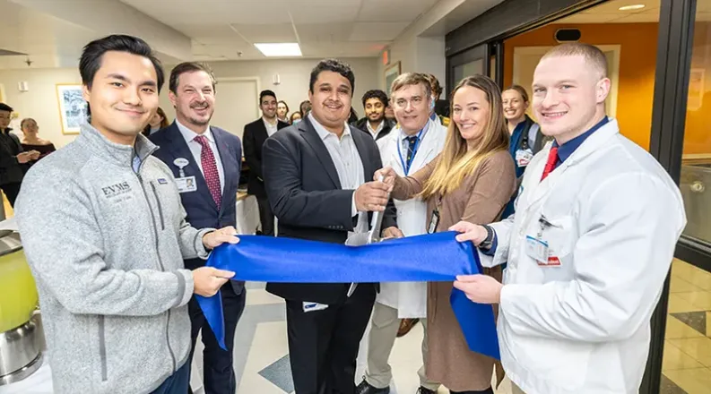 group of people cutting ribbon