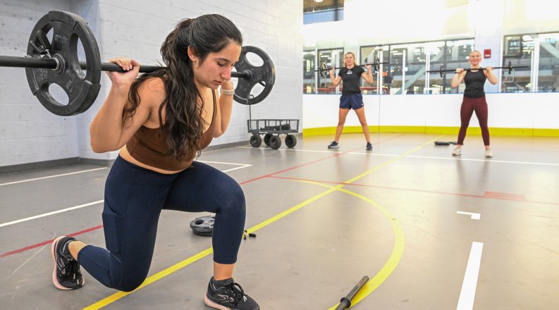 A woman performs lunges.