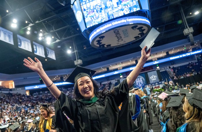 A student celebrates at commencement.