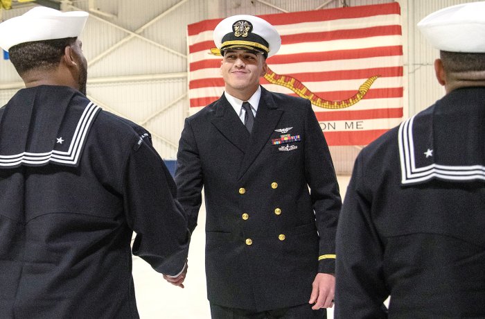 Juan Brambila shakes hands with someone.