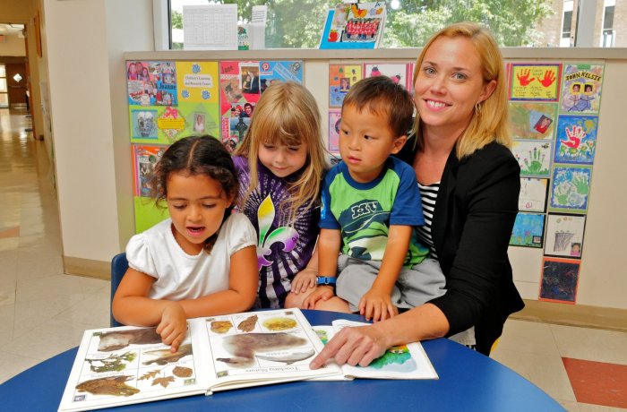 A photo of a teacher with a group of kids.