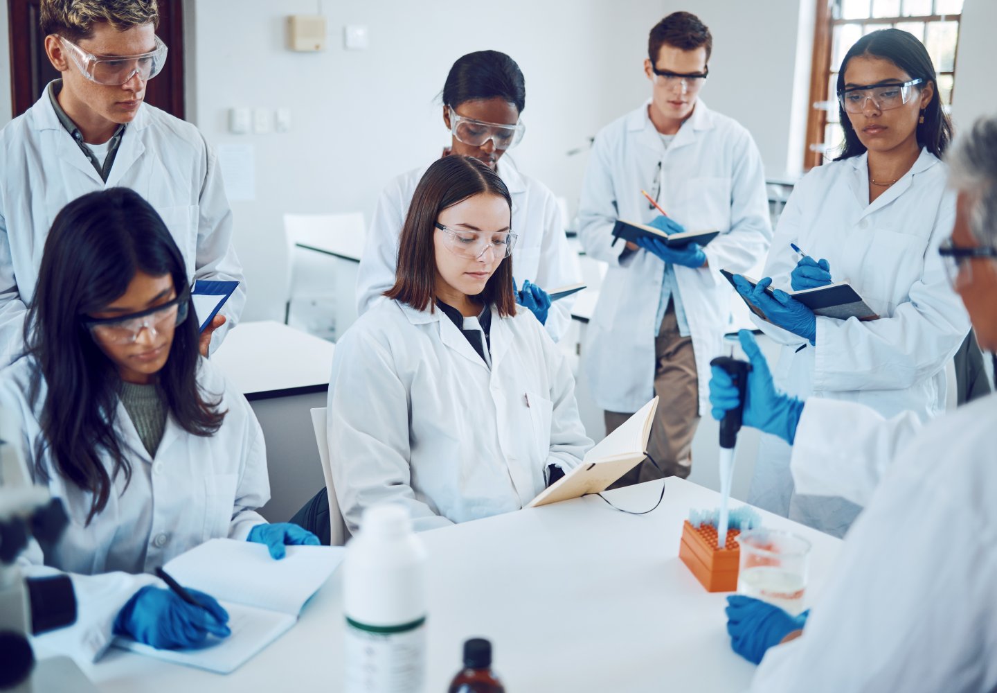 Science students writing notes in a laboratory