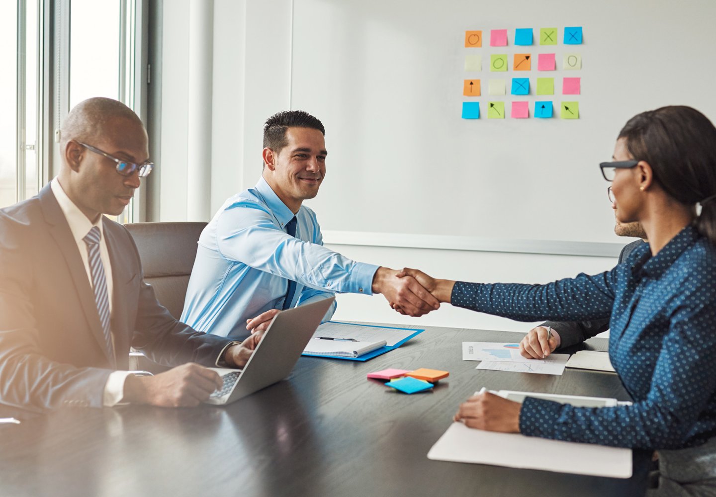 Professional shaking hands in meeting