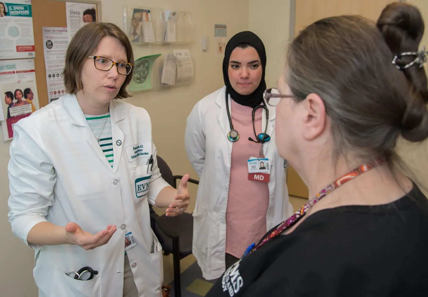 A physician and resident work with a patient at the Strelitz