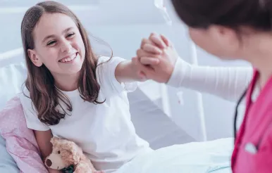 A fellow works with a patient in the ICU.