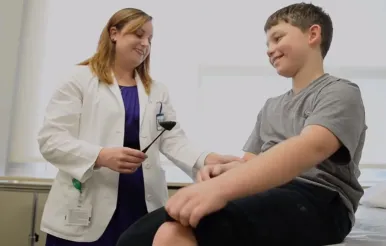 A fellow works with a 10-year-old standardized patient at EV