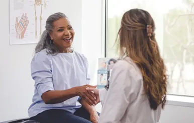 A doctor and patient sitting in an exam room.