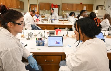 Biology students sit at lab tables in classroom