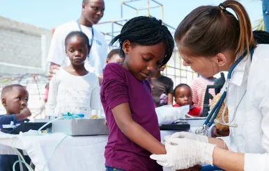 A fellow works with a child.