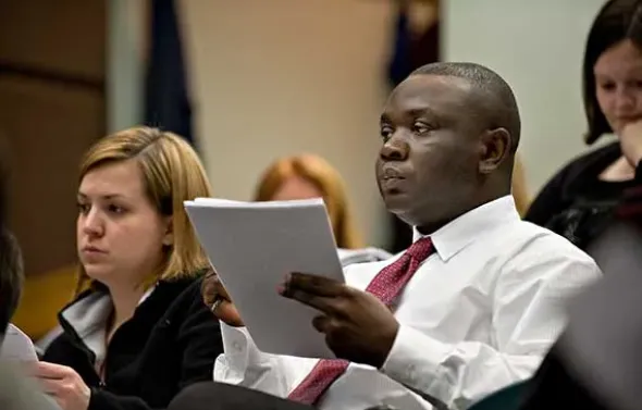Students take notes during a lecture.